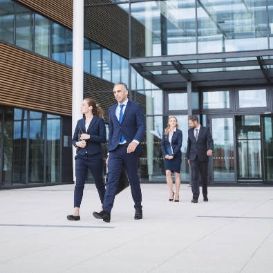 business people walking outside office building